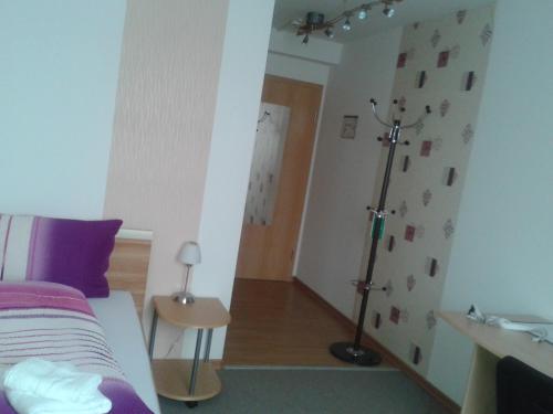 a bedroom with a bed and a lamp in it at Hotel Ackermann in Riedstadt