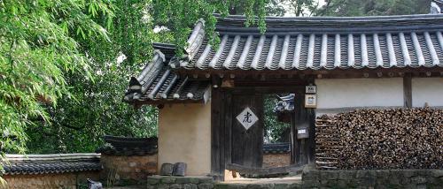 a wooden building with a sign on the side of it at Okyeon Jeongsa in Andong