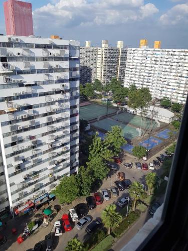 a view of a parking lot with parked cars and buildings at Smart Residence@Muengthongthani in Nonthaburi