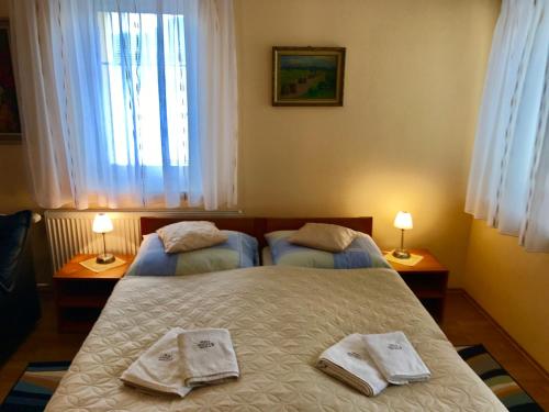 a bedroom with two twin beds with towels on them at Pension Avio Angels in Žiar nad Hronom