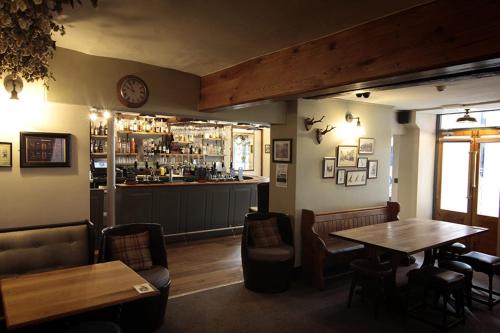 a restaurant with a table and chairs and a bar at Church Inn in Ludlow