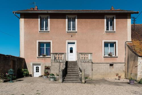 a large brick house with white doors and stairs at Chambre d'hôte l'épineuse in Venarey-les-Laumes