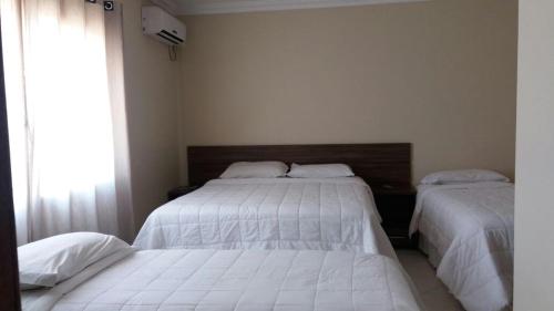 Ένα ή περισσότερα κρεβάτια σε δωμάτιο στο Imbau Palace Hotel