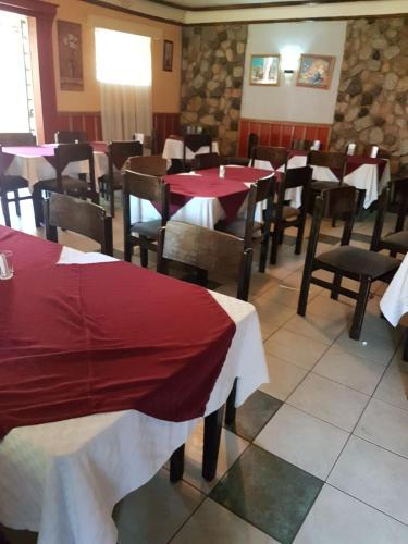 a restaurant with red and white tables and chairs at The Noble Hotel & Conference Centre in Eldoret