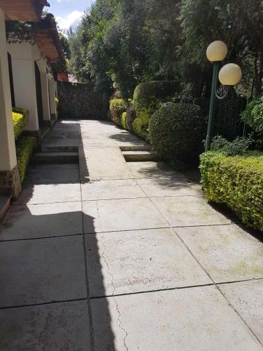 a shadow of a street light on a sidewalk at The Noble Hotel & Conference Centre in Eldoret