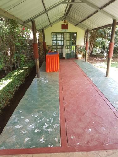 a red carpeted walkway with a table in a building at The Noble Hotel & Conference Centre in Eldoret