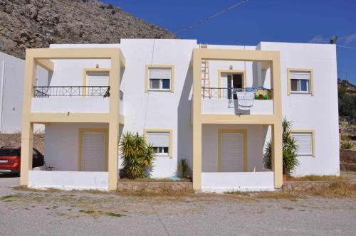 a white building with two balconies on the side of it at Marianthi Studios & Apartments in Pefki Rhodes