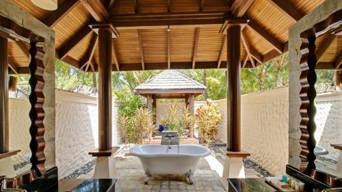 a bathroom with a tub and a gazebo at Sun Siyam Olhuveli in South Male Atoll
