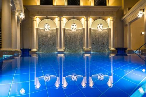 a pool in a hotel lobby with blue water at The Gainsborough Bath Spa - Small Luxury Hotels of the World in Bath