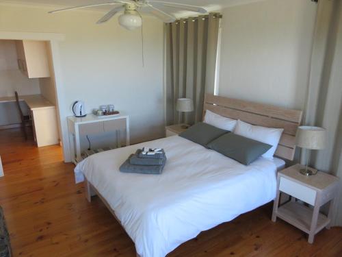 a bedroom with a white bed with a tray on it at The Noble Ant in George