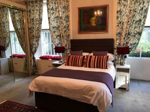 een slaapkamer met een groot bed en ramen bij 22 Chester Street in Edinburgh