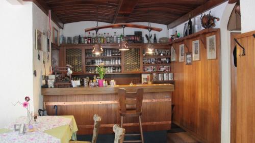 a bar in a restaurant with a table and chairs at Winzerschenke in Walporzheim