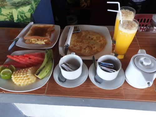 a table with a tray of breakfast food and a drink at Salili Bungalow in Gili Air