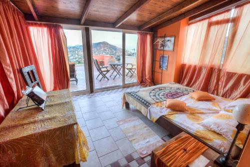 a bedroom with a bed and a large window at Casa di Luce in Aghia Marina