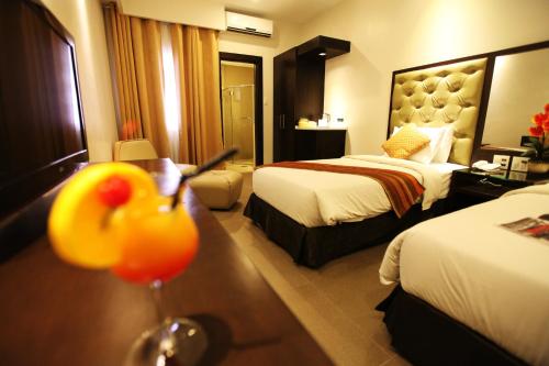 
a hotel room with a bed and a table at Castle Peak Hotel - Multiple Use Hotel in Cebu City
