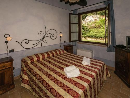 a bedroom with a bed with two towels on it at Farmhouse in Montoro near Montoro Castle in Narni