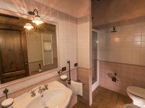 a bathroom with a sink and a toilet and a mirror at Farmhouse in Montoro near Montoro Castle in Narni