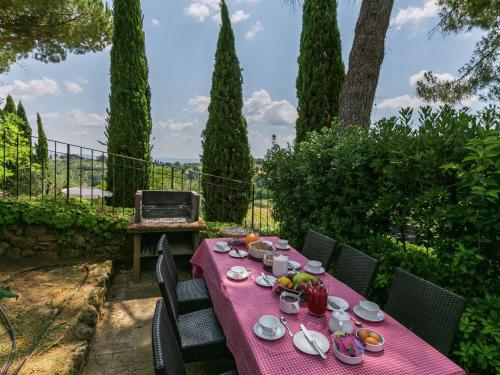 a table with a red table cloth with food on it at Villa in Siena with Pool and Tuscan Views in Siena