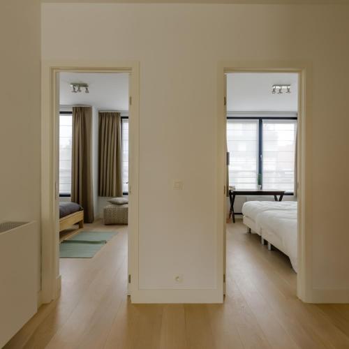 a bedroom with two mirrors and a bed in it at The Livorno in Brussels