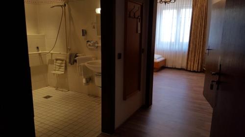 a bathroom with a sink and a tub and a toilet at Hotel Alt Steinbach in Steinbach im Taunus