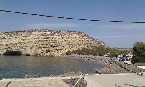 a group of people on a beach near the water at Studio Rafaela in Matala