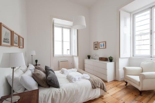 a living room filled with furniture and a window at Lisbon Charming Apartments - Chiado in Lisbon