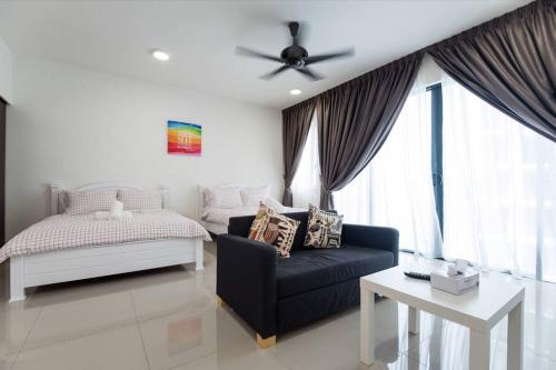 a living room with a couch and a bed at Studio Room next to SCCC at Trefoil Setia Alam for 2-4 pax in Setia Alam