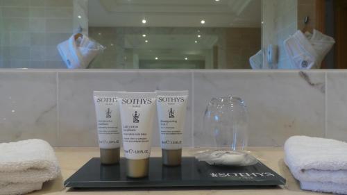 a display of some towels and someented products on a counter at Hotel & Spa Le Pavillon in Charbonnières-les-Bains