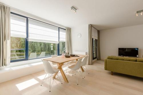 a living room with a table and chairs and a couch at The Livorno in Brussels