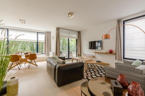 a living room with a couch and a table at The Livorno in Brussels
