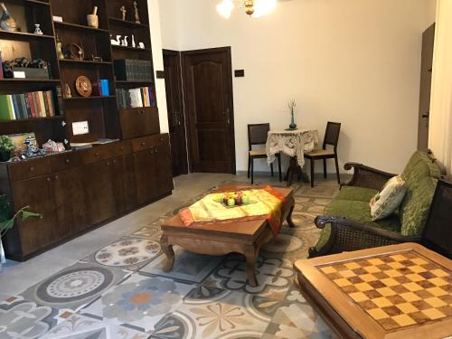 a living room with a table and a chess board at Mensa Christi Guesthouse in Nazareth