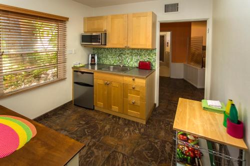 a small kitchen with a sink and a stove at Desert Riviera Hotel in Palm Springs