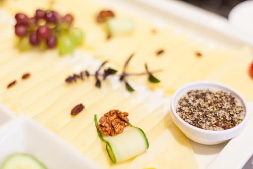 a plate of food with grapes and a bowl of nuts at Gasthof Ellmauer Hof in Ellmau