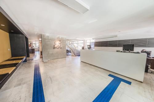 an office lobby with a pool and a reception desk at Bittar Inn in Brasilia