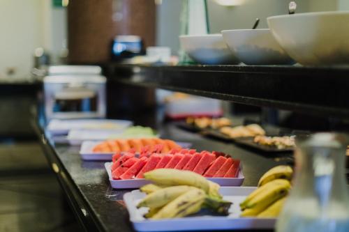 a buffet line with different types of food on plates at Monumental Bittar Hotel in Brasilia