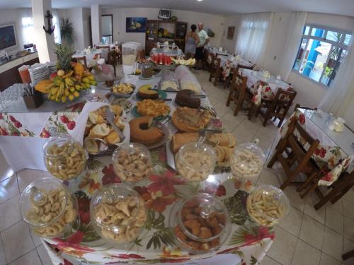a long table with many plates of food on it at Hotel Marlin Azul in Iriri