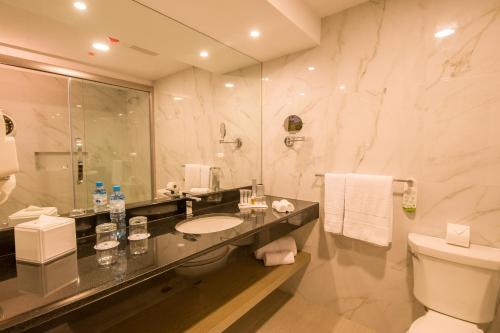 a bathroom with a sink and a toilet and a shower at Best Western Plus Urban Larco Hotel in Lima