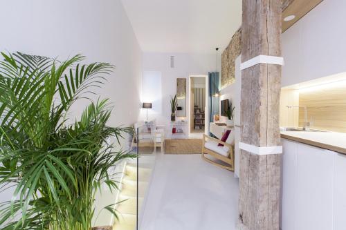 um quarto com paredes brancas e um piso branco com plantas em Madrid to heaven Apartment em Madrid