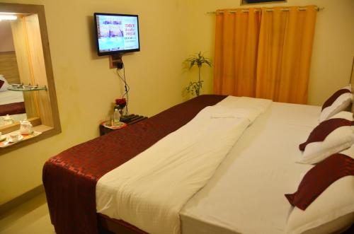 Katil atau katil-katil dalam bilik di Hotel Kaveri