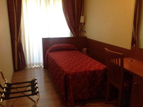 sypialnia z łóżkiem, stołem i oknem w obiekcie Guglielmo Marconi House w Rzymie