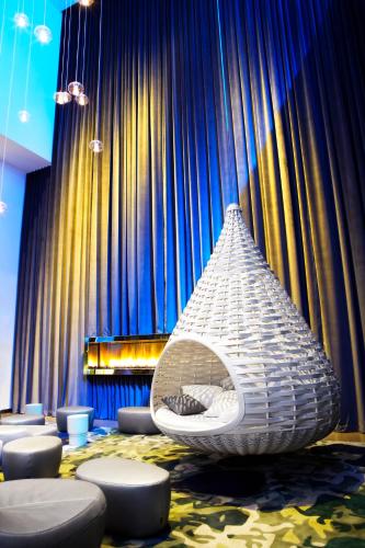 a room with a bed in front of a blue curtain at Radisson Blu Mall of America in Bloomington