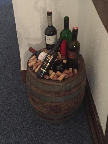 a barrel filled with bottles of wine and wine glasses at Gasthaus zum Goldenen Kreuz in Rafz