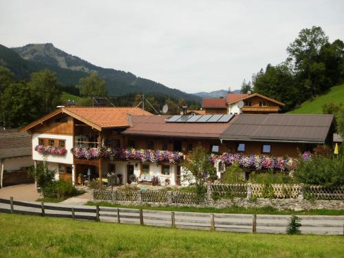 a house with solar panels on top of it at Badhaus in Achenkirch