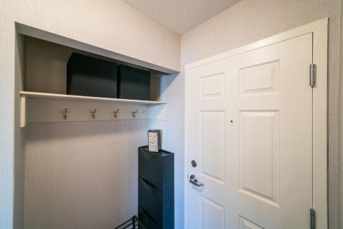 a room with a white door and a black cabinet at McKinnon Pointe #102 in Edmonton