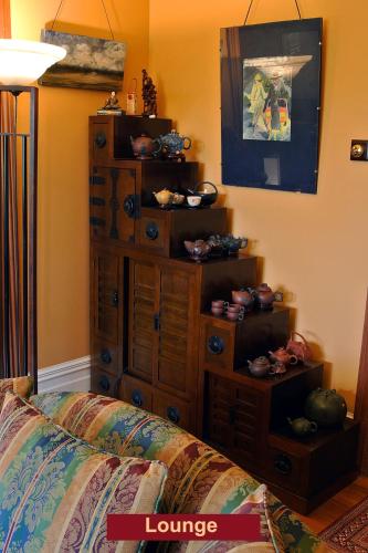 a living room with a dresser and a couch at The Grange in Auckland
