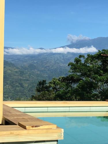 a swimming pool with a view of a mountain at Bella Vista Ranch Ecolodge in Turrialba