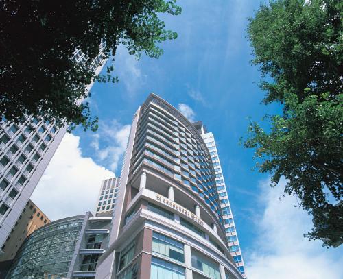 a tall building with a blue sky in the background at Marunouchi Hotel in Tokyo