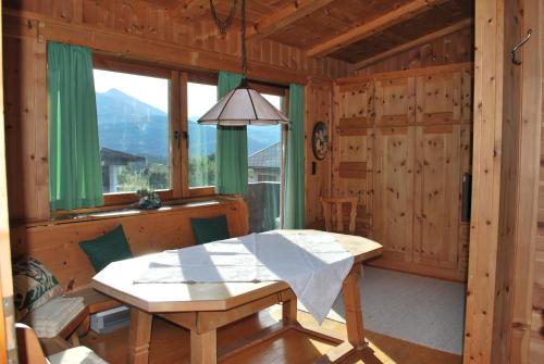 a wooden dining room with a table and a window at Appartement Seebacher in Hochfilzen