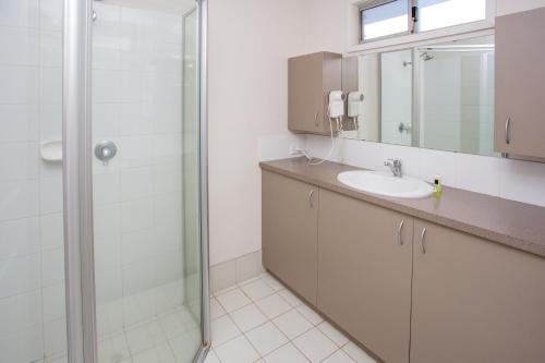 a bathroom with a sink and a shower at Discovery Parks - Pilbara, Karratha in Karratha