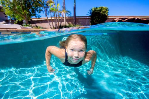 a young girl swimming in a swimming pool at Discovery Parks - Pilbara, Karratha in Karratha